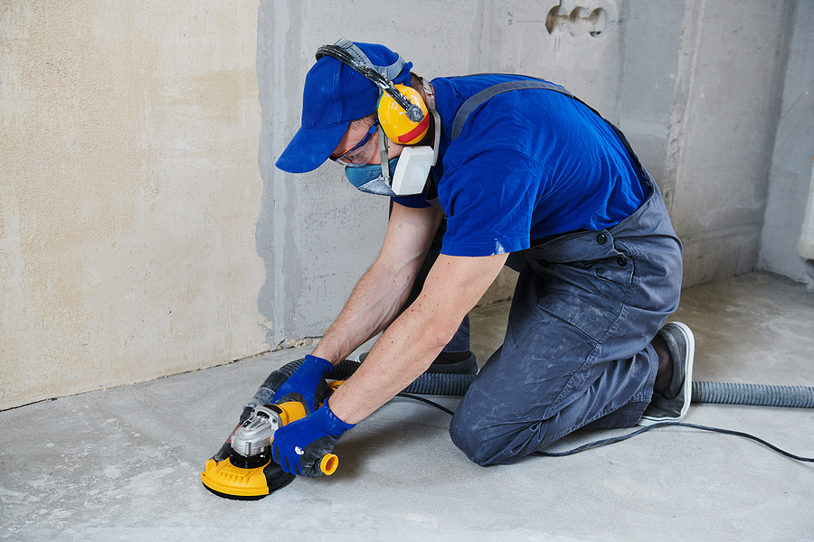 worker deep polishing concrete floor